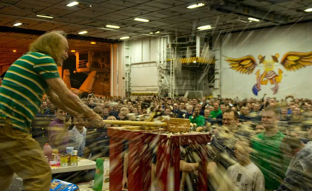 Guest swinging a sledgehammer in a smash session as debris flies